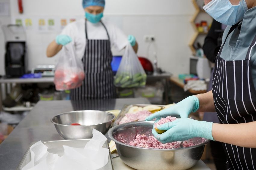 Food handlers practicing food safety to prevent contamination